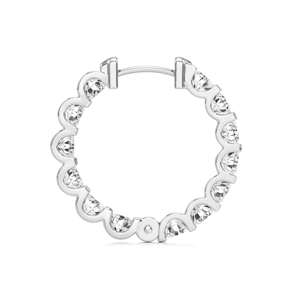 A silver-tone hoop earring with a scalloped wavy border, set with clear heart-shaped crystals, shown on a plain white background.