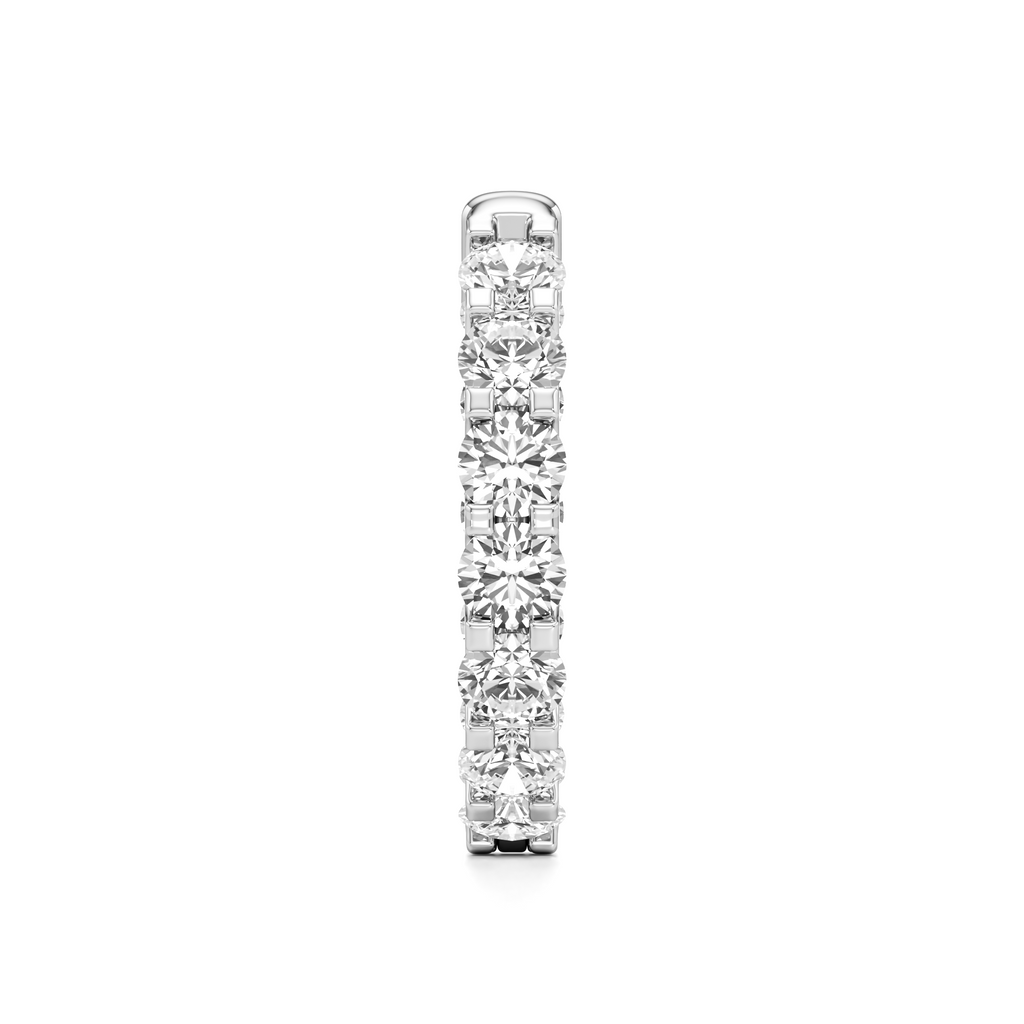 A slim silver-toned eternity ring featuring a continuous row of round-cut clear gemstones, shown vertically against a plain white background.