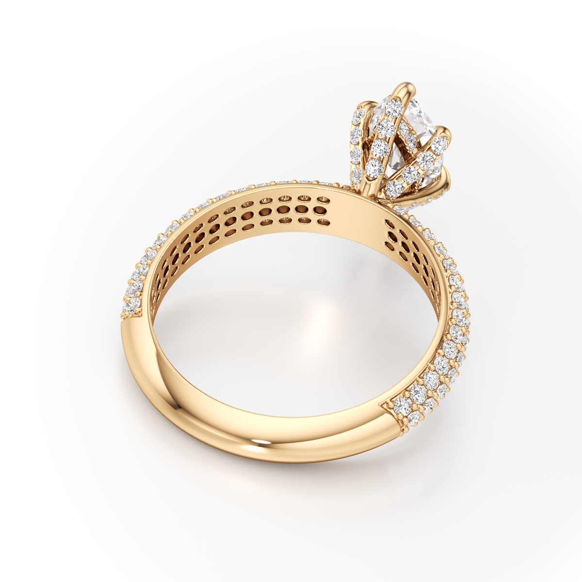 A yellow gold diamond ring shown from a side angle on a clean white background. The ring features a brilliant round-cut diamond center stone in a three-stone setting, with a pavé band accented with small round diamonds.