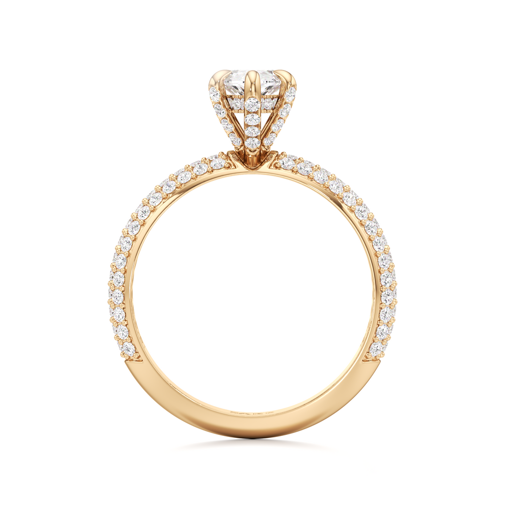 A yellow gold diamond ring with a round-cut center stone and pavé-set diamonds along the band, shown on a plain white background.