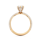 A yellow gold diamond ring with a round-cut center stone and pavé-set diamonds along the band, shown on a plain white background.