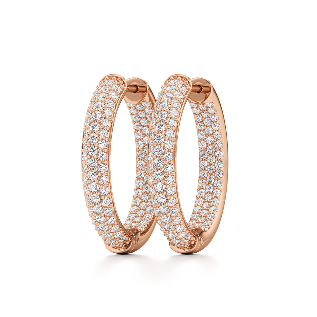 Pair of rose-gold oval pavé hoop earrings displayed at an angle to show their shape and stone detailing.