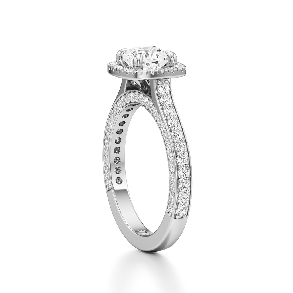 A silver-toned diamond engagement ring with a round-cut center stone and pavé-set diamonds along the shank, shown on a clean white background.