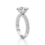 A silver-toned solitaire engagement ring featuring a large round brilliant-cut center stone and a twisted band pavé-set with small round diamonds, shown on a clean white background.