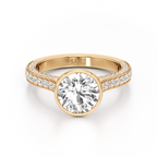 A yellow gold engagement ring featuring a large round-cut center stone and pavé-set side stones on a clean white background. The inside of the band is engraved with the brand name 'SAKE'.