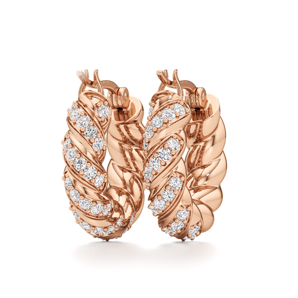 Pair of Helix twisted hoop earrings displayed at an angle, showcasing their sculptural curves and decorative stone details.