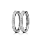 A pair of silver hoop earrings paved with small clear stones, shown on a clean white background.