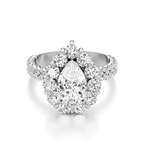 A pear-cut diamond engagement ring with a halo setting and a diamond-encrusted split shank, shown on a clean white background.