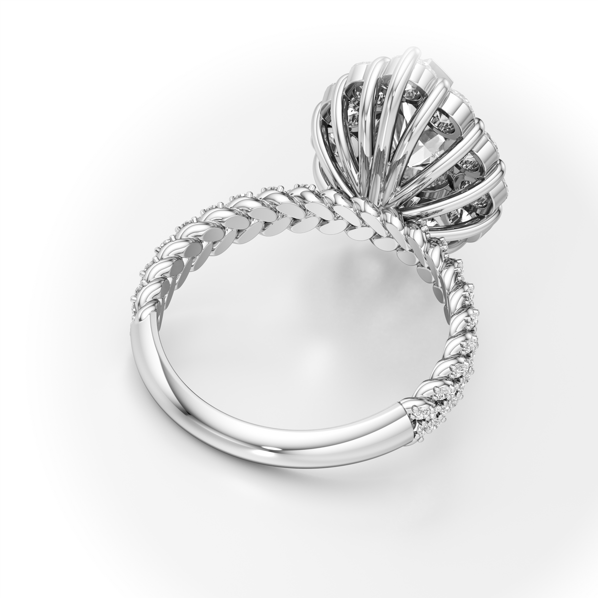 A silver-toned ring featuring a sculptural, fan-like cluster of prongs set with small clear stones, mounted on a twisted rope-style band with small accent stones, shown on a clean white background.
