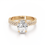 A yellow gold engagement ring featuring a large oval-cut center diamond and pavé-set diamonds along the shank, with the brand name 'SAKE' engraved inside the band, shown on a clean white background.