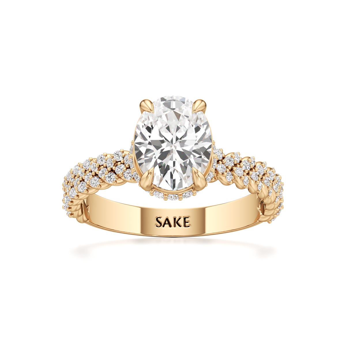 A yellow gold engagement ring featuring a large round-cut diamond center stone and a pavé-set diamond band, with the brand name 'SAKE' engraved on the inner band, set against a plain white background.