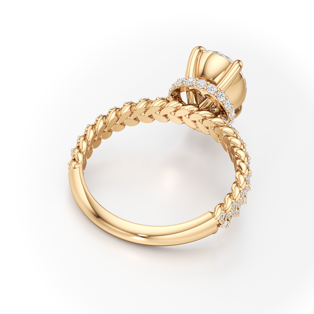 A yellow gold ring with a braided band, a halo setting, and small pavé-set clear stones, shown on a clean white background.