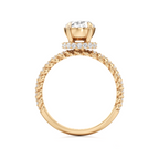 A yellow gold ring with a twisted rope band, a halo of small diamonds, and a large round-cut center diamond, shown on a plain white background.